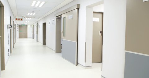 Female doctor examining x-ray in corridor at hospital