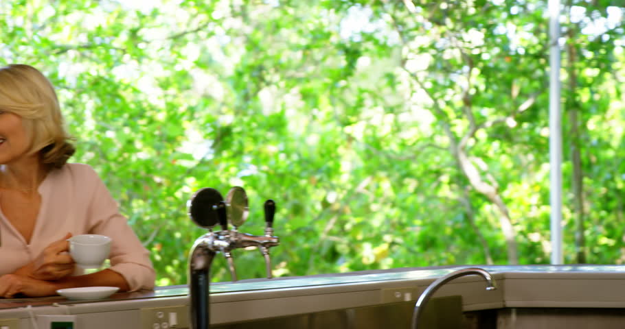 Couple interacting while having coffee at outdoor café