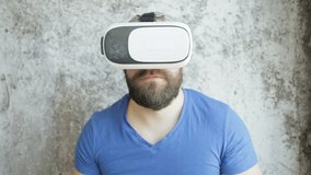 business,technologies, VR, people and lifestyle concept - Bearded man uses VR-headset display with headphones for virtual reality game