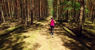 Sport fit girl  running in beautiful  sunny forest