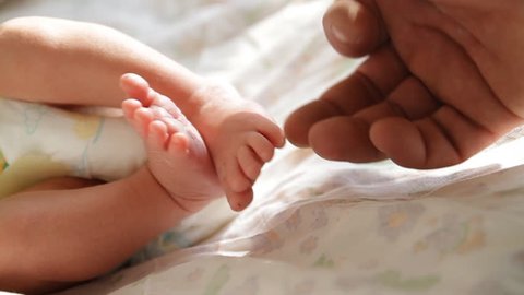 Touching newborn baby's feet Stock Video