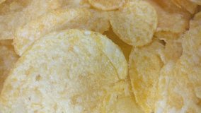 Great background of delicious Potato chips rotating close up. Footage will work great for any videos dealing with nutrition, relaxation, fun, friendship and much more.