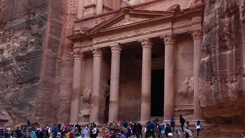 JORDAN, PETRA, DECEMBER 5, 2016: People near Al Khazneh or the Treasury at ancient Petra, originally known to Nabataeans as Raqmu - historical and archaeological city in Hashemite Kingdom of Jordan