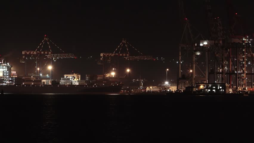 Ship crosses at night in Durban harbor