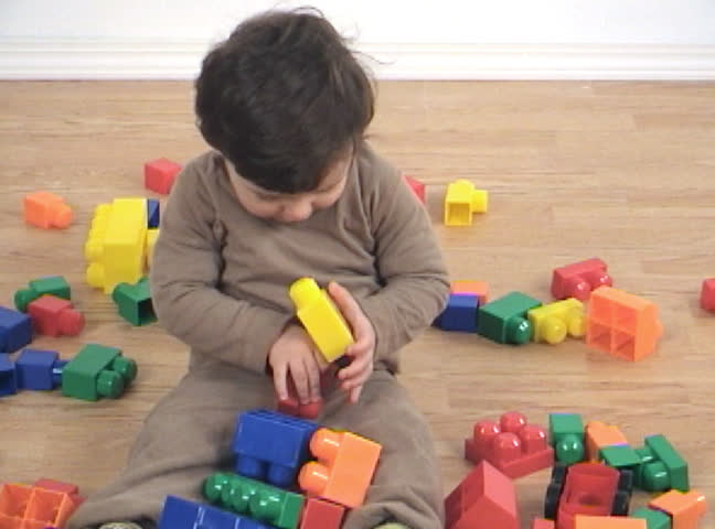 baby playing with toys on floor
