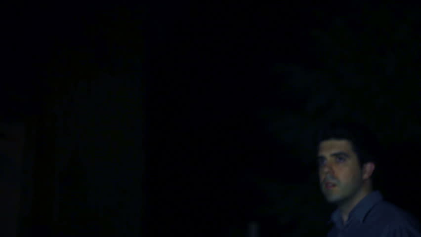 worried man searching at night.