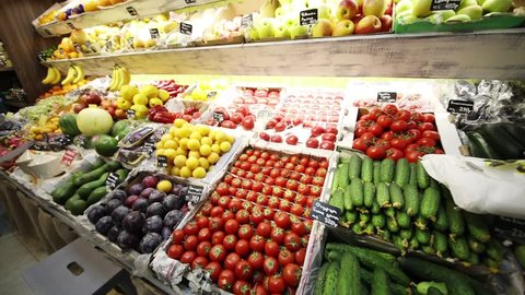 Many vegetables, fruits in food shop, Text translation - Tomatoes, cucumbers, cherry, apples Simirenko