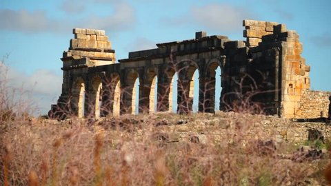 Tight, slider shot of ancient Roman ruins at the archaelogical UNESCO Heritage site of Volubilis in Morocco.