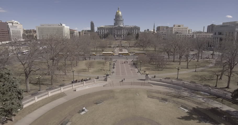 Aerial shot of people and cars on a busy day in Downtown Denver near federal building.