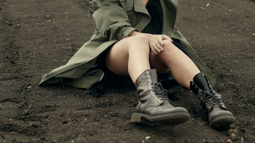 Model in coat posing on ground