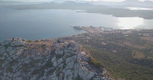 View from above. Aerial video shot by a drone of a trekking to the top of the mountain at sunset. Emerald coast, Sardinia, Italy.	
