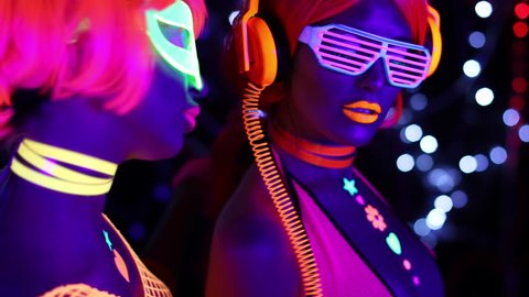 4k fantastic video of 2 sexy cyber glow raver women filmed in fluorescent clothing under UV black light