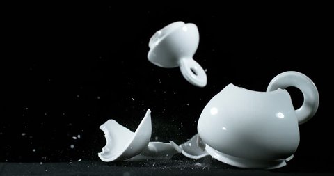Tea-Pot falling and exploding on Black Background, Slow Motion 4K