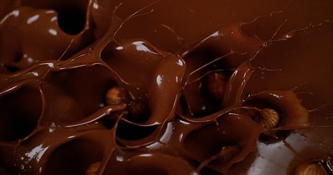 Hazelnuts Falling in Milk Chocolate, Slow Motion 4K