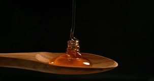 Honey Flowing against Black Background, Slow Motion 4K