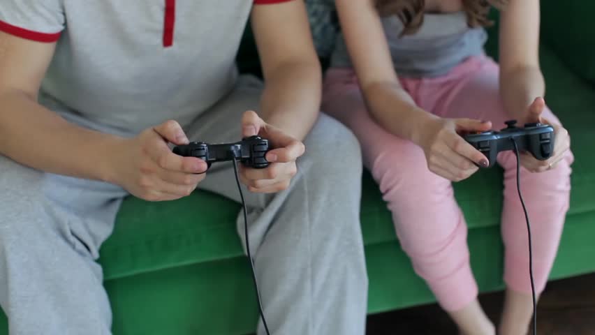 Close-Up, Man And Woman Play Joysticks in The Console