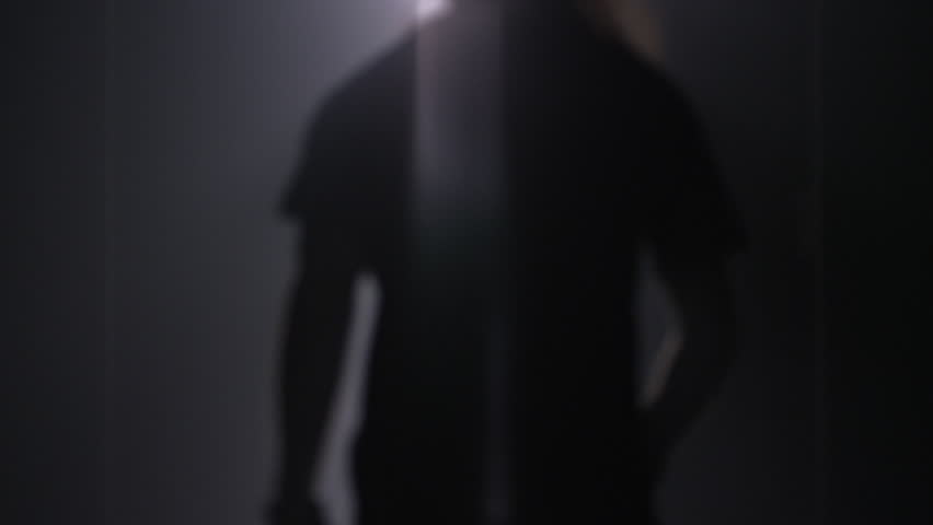 Man silhouette back going to the light at night. Male silhouette going to bright light. Man silhouette walking to light in the darkness. Man open door light in dark. Escape concept Royalty-Free Stock Footage #27359629