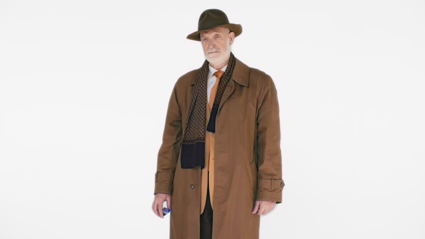 Older charming man in the hat with a plastic Bank card on white background