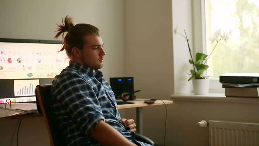 Worried man sitting in the office at home and thinking about something
