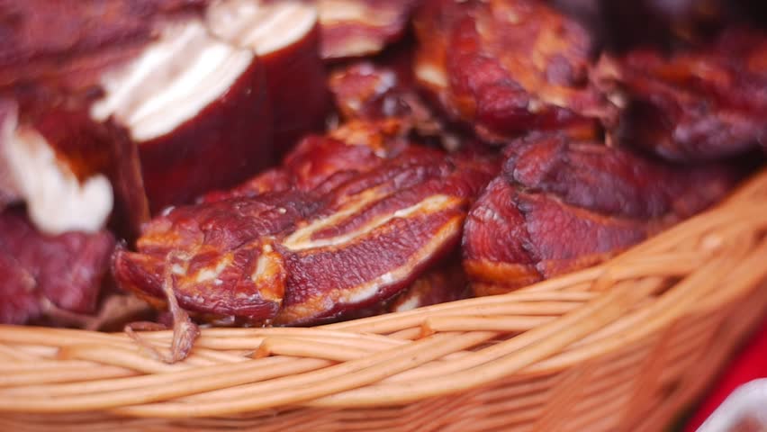 Expensive Pork Cutting on a Show-Window of Known Grocery. She Lies in a Beautiful Willow Basket. Some Meat Pices Was Cuted Half-And-Half. Meat Looks Extraordinary Tasty. His Pleasant Aroma is Audible