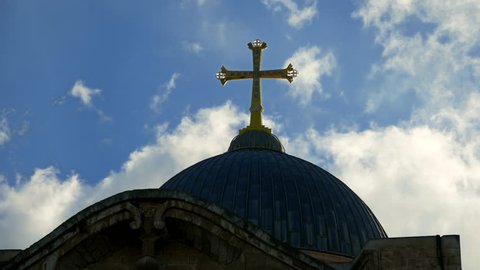 Golden cross over Temple of the Holy Sepulcher church in Jerusalem timelapse. The Holy Sepulchre Church is the most sacred place for all Christians in the world.