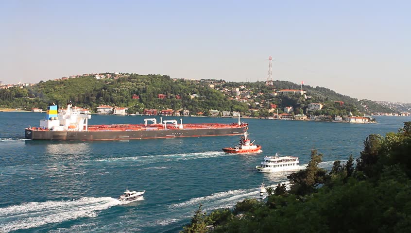 Crude oil tanker with a tug boat sails through Straits Bosporus in Istanbul,