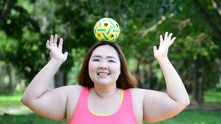 Beautiful fat woman play rattan ball in the park , South Asian Thailand Shu...