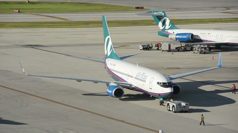 FORT LAUDERDALE - AUGUST 9: Air Tran Boeing 737 passenger jet arrives in Fort Lauderdale, FL on August 9, 2012. Air Tran was recently acquired by Southwest Airlines