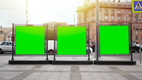 A Billboard with a Green Screen on a Busy Street