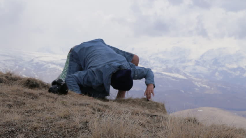 Traveler sets action camera for takes pictures of the mouintains landscape. Man taking photo at beautiful rocky place with action camera and professional DSLR camera.