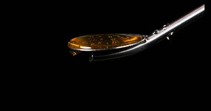 Honey Flowing from Spoon against Black Background, Real Time 4K