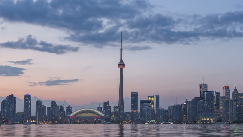 Time lapse Toronto Skyline and CN Tower with Rogers Center during twilight and