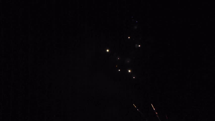 Celebration of lighting off large fireworks at night.