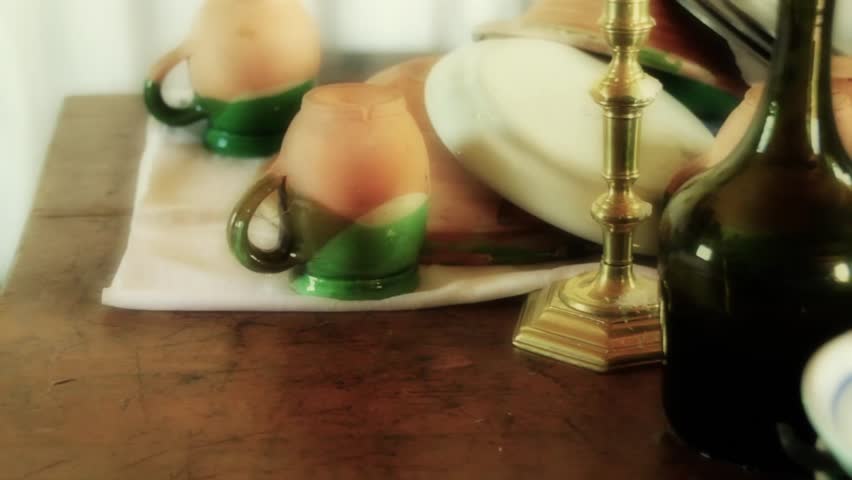 A table with old dishes at the French Fort and 18th Century Colonial Town at Louisbourg Nova Scotia Canadian National Park.