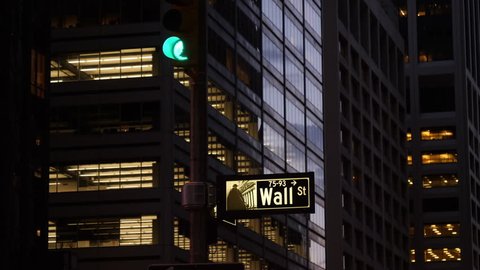 New York City, May 2017. Wall Street sign in business district at night.
