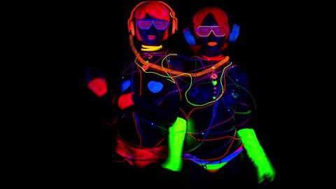 4k fantastic video of 2 sexy cyber glow raver women filmed in fluorescent clothing under UV black light