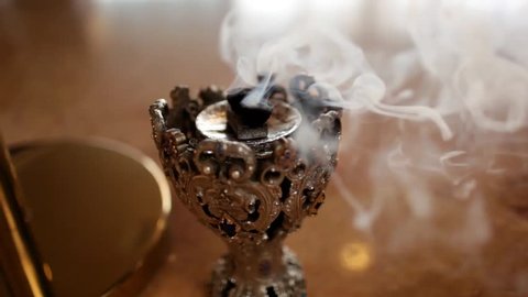 Smoking incense in the room, close-up