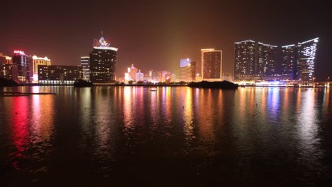 Macau, China - December 9, 2016: Cityscape time lapse with Wynn Macau, MGM Macau, Casino Lisboa and Grand Lisboa Hotel reflected in Nam Van Lake, a man-made lake in southern end of Macao Peninsula.