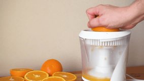 Make fresh orange juice with electric juicer. FHD video