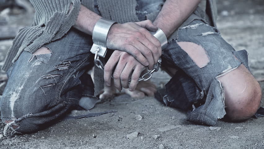 a prisoner in chains on his knees Royalty-Free Stock Footage #27434401