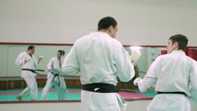 Two karate players compete in the ring