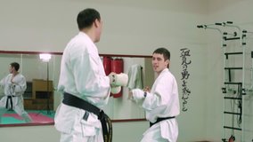 Two karate players compete in the ring