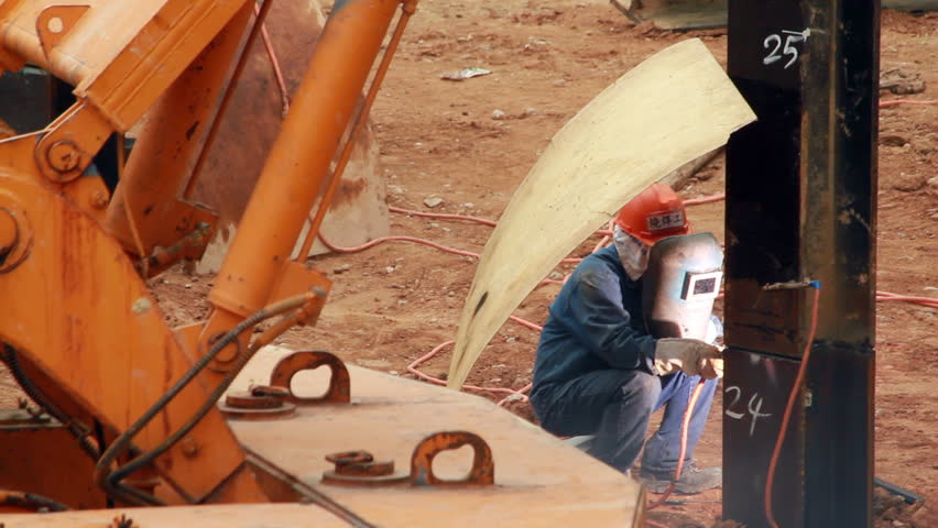 Steel beam welding at a construction site