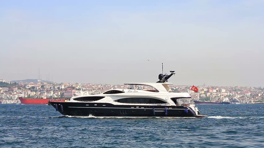 Luxury black yacht sails in Bosporus waters
