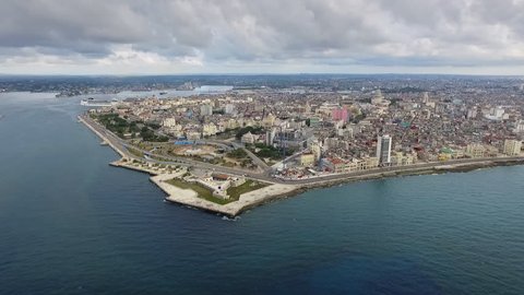Drone flying over Havana, Cuba: Caribbean sea and Malecon promenade. Aerial view of La Habana skyline, Cuban capital city. Urban landscape seen from the sky with old buildings and ocean