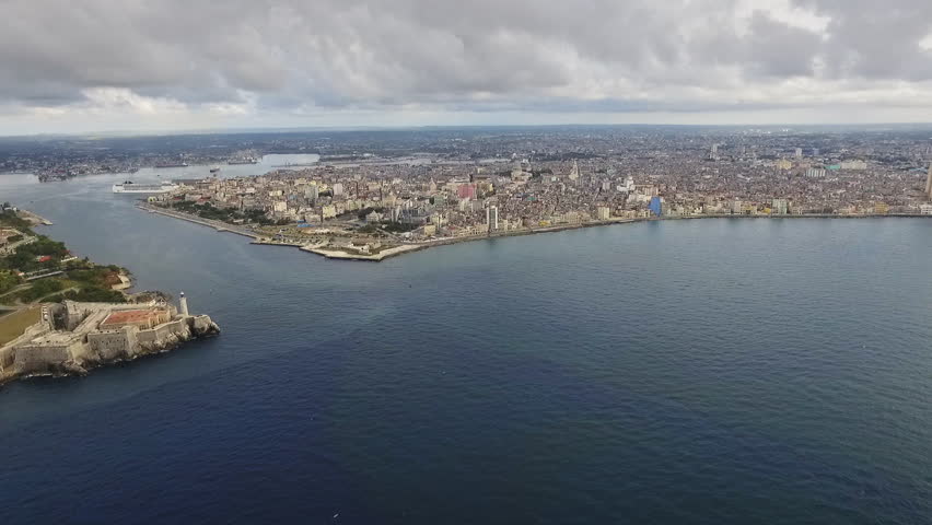 Drone flying over Havana, Cuba: Morro Castle and Malecon promenade. Aerial view of La Habana skyline, Cuban capital city. Urban landscape seen from the sky with old monument, landmark, Caribbean sea