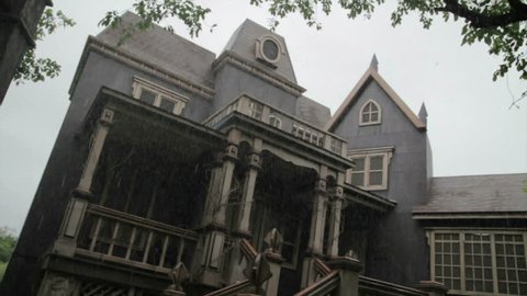 Creepy old haunted house in the rain