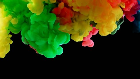 Colorful rainbow paint drops from above mixing in water. Ink swirling underwater. Cloud of ink isolated on black background with alpha. Colored abstract smoke explosion animation effect. Close up view