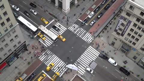 New York City - Circa 2017: Aerial view of midtown Manhattan intersection day time establishing shot. Overhead birds eye view of busy traffic pedestrian crosswalk grid