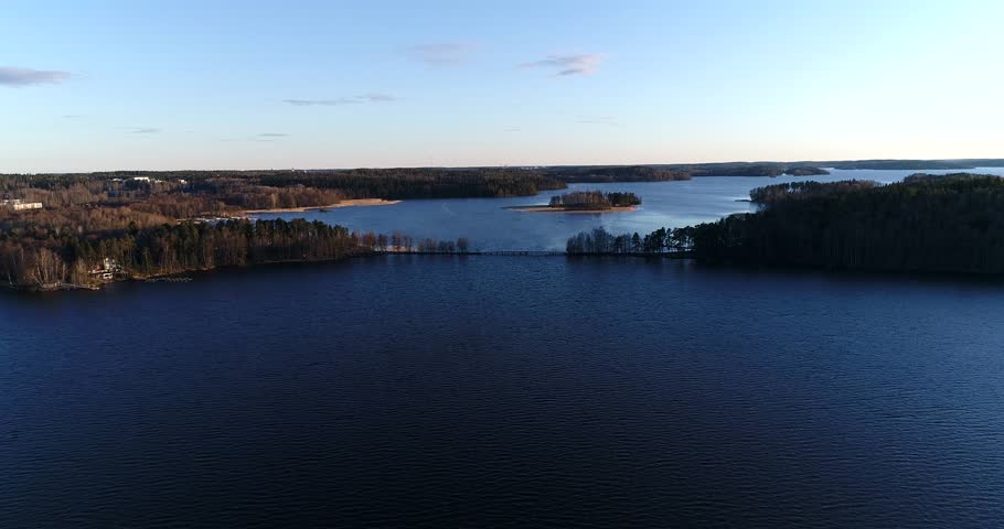Lohjajarvi, Cinema 4k aerial view of a flight towards liessari bridge, in lohjanjÃ¤rvi, on a sunny spring evening, in Lohja, Finland